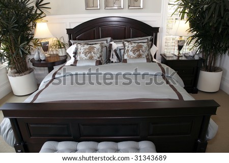 Comfortable modern designer bedroom with stylish furniture and decor.