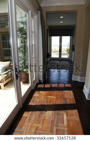 Mansion hallway with a hardwood floor.