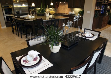 Luxury home dining table with kitchen in the background.