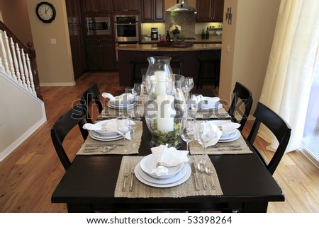 Dining table with contemporary tableware and festive decor.