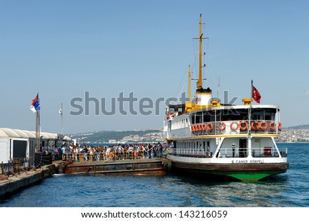 ISTANBUL - JUNE 9: People get on board the ship at Karakoy Pier on June 9, 2013 in Istanbul. Nearly 150,000 passengers use ferries daily in Istanbul, due to easy access to two different continents.