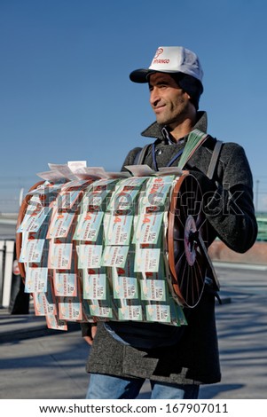 ISTANBUL, TURKEY - DEC 8, 2013: Lottery ticket seller. Established in 1939, the National Lottery in Turkey in the country, has been organizing all kinds of games of chance. Dec 8, 2013