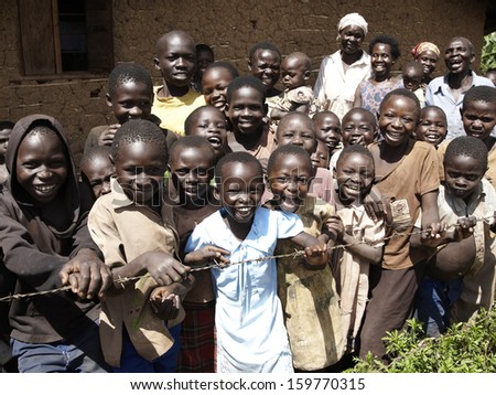 Kapchorwa, Uganda - Circa January 2010 : Children In The Village Stands Behind At Barbwire Fence.