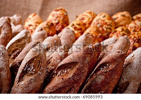 Rows of various bakery products close up on brown background