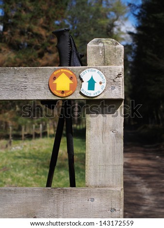 Wooden fence with hiking poles and scottish right of way sign