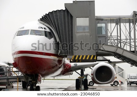 horizontal image - front view of docked jet plane preparing for flight