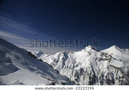 Snowy mountains landscape, dark blue sky