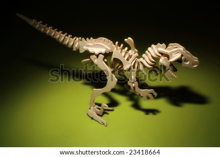 Wooden toy Dinosaur Skeleton on Black green background