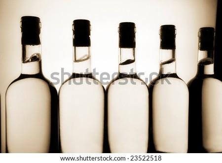 Silhouettes of white wine bottles on a production line