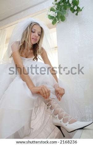 The Young bride before rite. White gown bridal veil