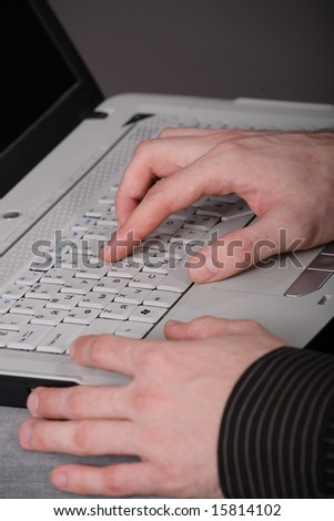 human hands typing on laptop