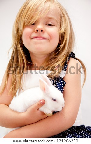 Little Girl Embracing Her Pet Rabbit