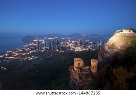 Erice, near Trapani in Sicily; view from Venus Castle at night. On the background, the reserve of mount Cofano, and the lights of the towns of Custonaci and Valderice