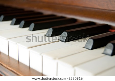 Closeup of antique piano keys shallow depth of field focus on ebony keys
