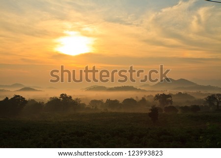 layers of mountains and fog at sunrise