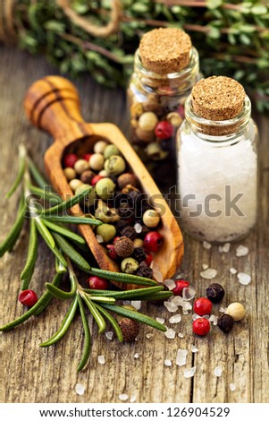 Herbs, salt and pepper on wooden table