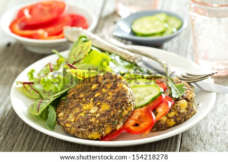 Vegan chickpeas burgers with salad and vegetables