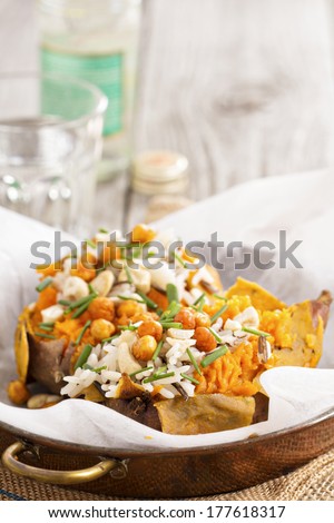 Baked sweet potato stuffed with rice, chives and roasted chickpeas