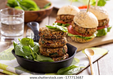 Vegan burgers with  beans and vegetables served with spinach