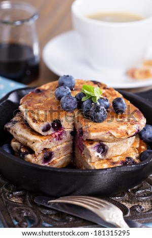 Eggless pancakes with banana and blueberries in a small pan