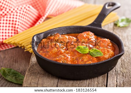 Meatballs with tomato sauce in a small pan
