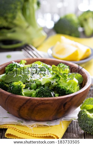 Lemon broccoli with peas and mint in a wooden bowl