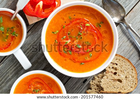 Roasted red pepper and carrot soup in white bowl