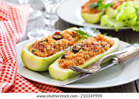 Vegan stuffed squash with millet, tomatoes and olives