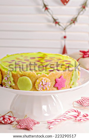 Cheesecake for christmas with colorful jelly on top, marzipan decoration and mint candies