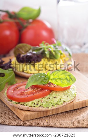 Vegan sandwich with avocado, vegetables and scrambled tofu
