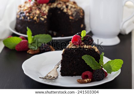 Chocolate banana cake with nuts decorated with berries