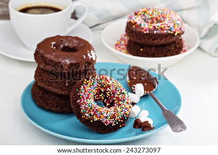 Stack of homemade baked chocolate donuts with glaze