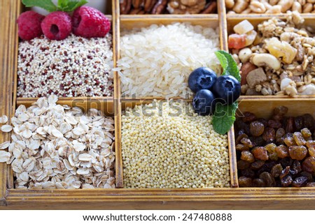 Breakfast items in wooden box with grains and berries