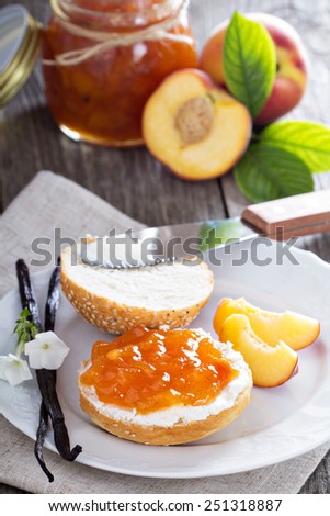 Bread with cream cheese and peach jam for breakfast