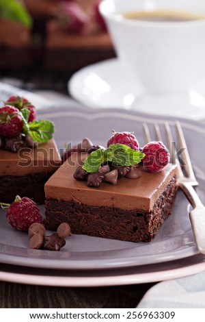 Chocolate mousse brownies with raspberry on a plate