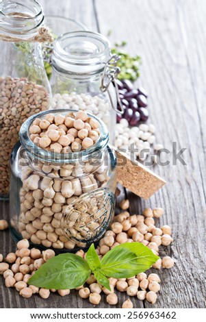 Raw beans and lentils in glass jars and bottles