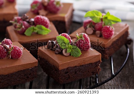 Chocolate mousse brownies with raspberry on a cooling rack