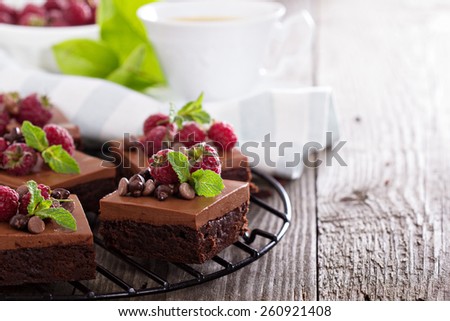 Chocolate mousse brownies with raspberry on a cooling rack