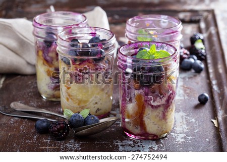 Bread, milk and blueberry pudding in mason jars