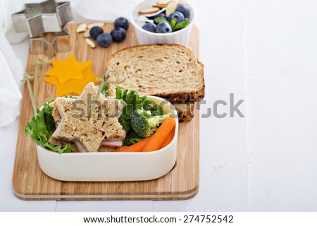 Lunch box with sandwich, carrots and salad