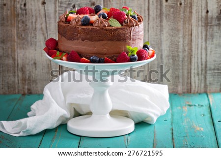 Chocolate cheesecake and devil food layer cake with fresh berries