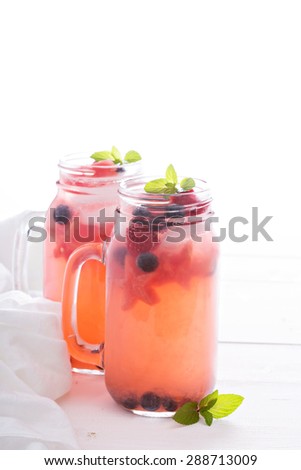 Watermelon lemonade with blueberries and ice cubes, watermelon stars in mason jars