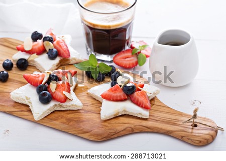 Star shaped sandwiches with berries, almonds and cream cheese