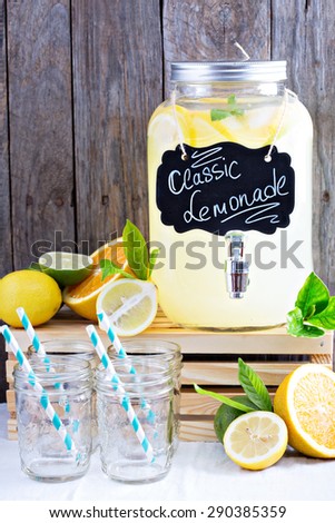 Homemade lemonade in beverage dispenser with fresh lemons