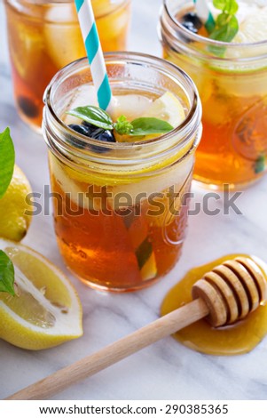 Homemade honey iced tea in mason jars with straws