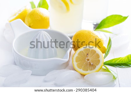 Making homemade lemonade with ceramic juicer with fresh lemons
