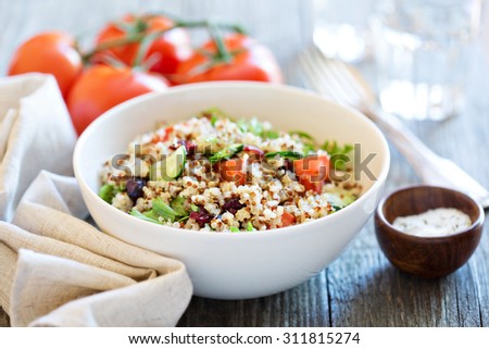 Quinoa salad with fresh tomatoes, cucumbers and salad leaves