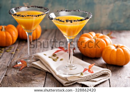 Pumpkintini pumpkin martini coctail with black salt rim for fall and halloween parties