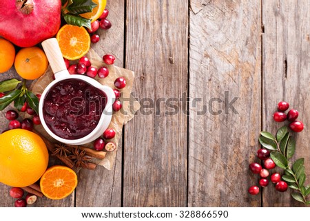 Cranberry sauce in ceramic saucepan on dark background