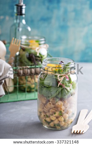 Assembling a mason jar salad for a lunch to go